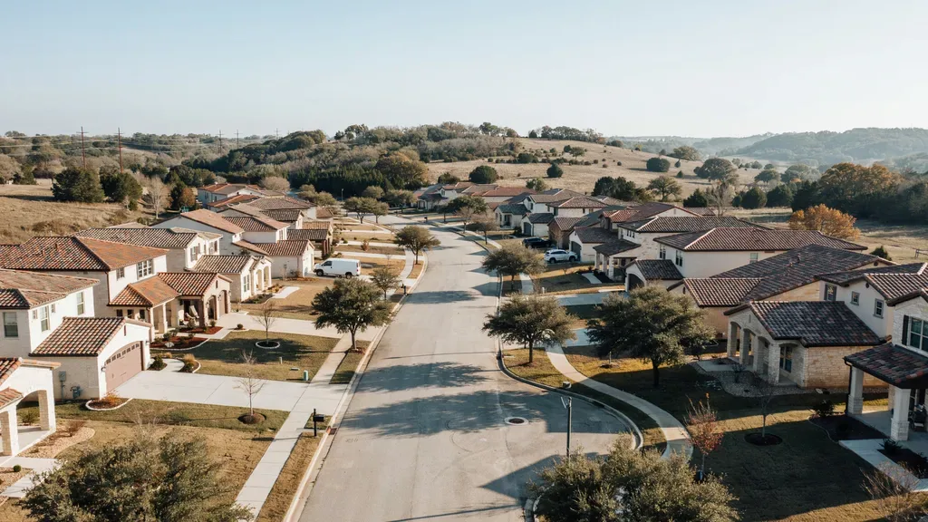 Windshield replacement service area Leander TX - Hill Country neighbourhood with a mobile auto glass van in a driveway